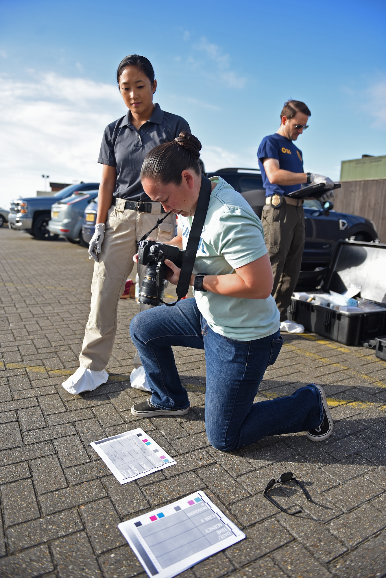 U.S. Air Force Senior Airman Alexandra West, 100th Air Refueling Wing Public Affairs broadcast journalist, documents a photo identifier before going into a simulated crime scene during crime scene processing training at RAF Mildenhall, England, Aug. 1, 2018. The training included members of Air Force Office of Special Investigations Detachment 512, 100th Security Forces Squadron Intelligence and Investigations unit and 100th ARW Public Affairs, who worked together to compare and develop crime scene processing skills. (U.S. Air Force photo by Senior Airman Luke Milano)