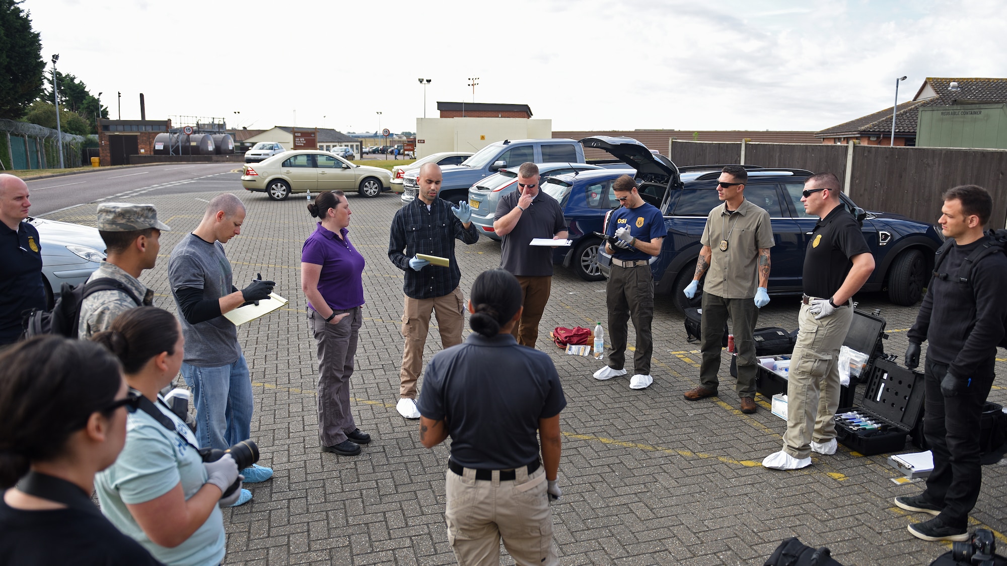 U.S. Air Force Special Agent Mark Stuetzel, Air Force Office of Special Investigations Detachment 512, briefs Airmen during crime scene investigation processing training session at RAF Mildenhall, England, Aug. 1, 2018. This was the first time the three agencies came together to conduct crime scene investigation training at RAF Mildenhall. (U.S. Air Force photo by Senior Airman Luke Milano)