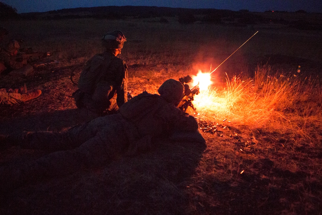U.S. Marines with Special Purpose Marine Air-Ground Task Force-Crisis Response-Africa fire an M-240B medium machine gun during a night unknown-distance range in Baumholder, Germany, July 25, 2018. SPMAGTF-CR-AF deployed to conduct crisis-response and theater-security operations in Europe and Africa.
