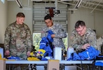 Spec. Derek Price, Pfc. Joshua Taulaga and Spec. Austin Miller with the 176th Engineer Company inventory the new equipment they received prior to going to help fight wildfires impacting Eastern Washington, Aug. 1, 2018, at Camp Murray, Washington.