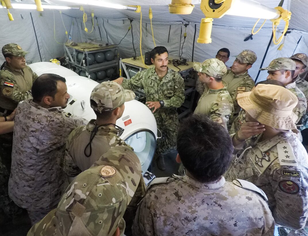 Chief Hospital Corpsman Eli Hernandez explains how the decompression chamber operates to participants of Eagle Response 18. Eagle Response 18 is an explosive ordnance disposal and diving exercise with the Egyptian Naval Force conducted to enhance interoperability and war-fighting readiness, fortify military-to-military relationships and advance operational capabilities of all participating units. (U.S. Navy photo by Lt. Chloe Morgan/Released)