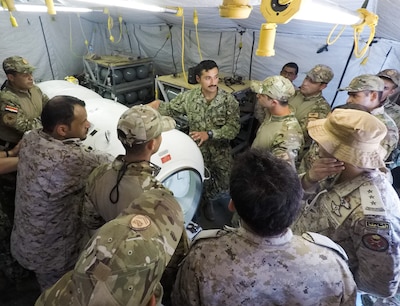 Chief Hospital Corpsman Eli Hernandez explains how the decompression chamber operates to participants of Eagle Response 18. Eagle Response 18 is an explosive ordnance disposal and diving exercise with the Egyptian Naval Force conducted to enhance interoperability and war-fighting readiness, fortify military-to-military relationships and advance operational capabilities of all participating units. (U.S. Navy photo by Lt. Chloe Morgan/Released)