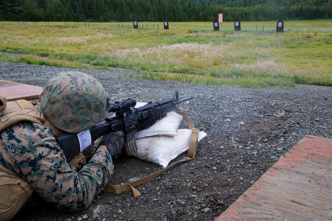 Lance Cpl. Joel Carrizales, with Charlie Company, 1st Battalion, 25th Marine Regiment, zeroes in his rifle at the 25-yard-line, Joint Base Elmendorf-Richardson, Anchorage, Alaska, August 1, 2018. Super Squad Competitions were designed to evaluate a 14-man infantry squad throughout an extensive field and live-fire evolution. (U.S. Marine Corps photo by Lance Cpl. Samantha Schwoch/released)