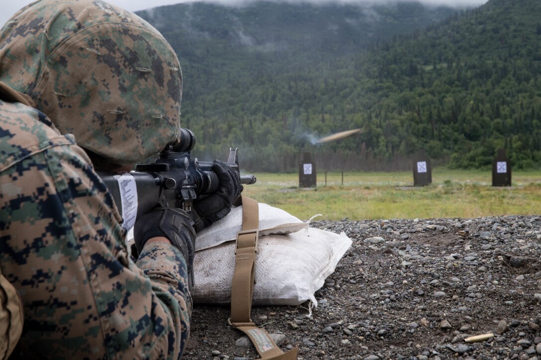 Lance Cpl. Joel Carrizales, with Charlie Company, 1st Battalion, 25th Marine Regiment, zeroes in his rifle at the 25-yard-line, Joint Base Elmendorf-Richardson, Anchorage, Alaska, August 1, 2018. Super Squad Competitions were designed to evaluate a 14-man infantry squad throughout an extensive field and live-fire evolution. (U.S. Marine Corps photo by Lance Cpl. Samantha Schwoch/released)