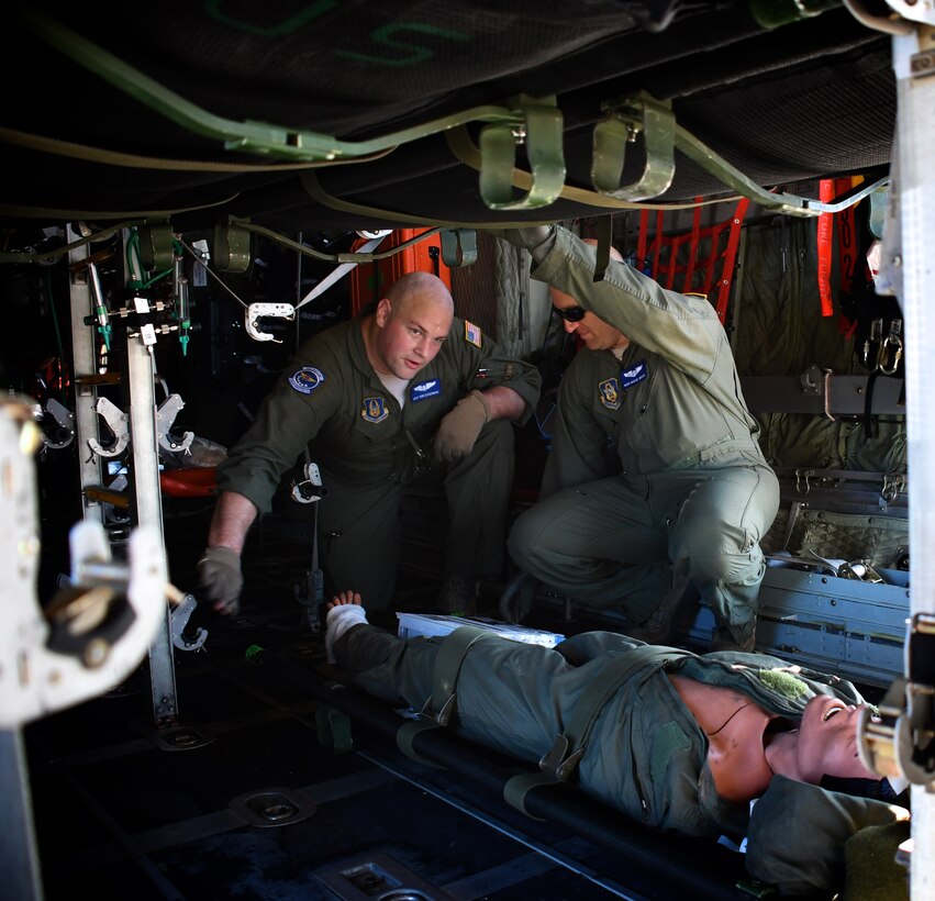 932nd Aeromedical Evacuation Squadron medical members make final arrangements and secure medical equipment as they work together with ground crew, preparing to fly with "simulated patients" during a training flight, July 21, 2018 at Scott Air Force Base, Ill.  Staff Sgt. Don Ackerman and Senior Master Sgt. Michael Mikoff watch over their "patient" as the engines start on a C-130 plane.  The AES trained alongside fellow nurses and medical technicians on a multi day flight aboard a C-130 aircraft visiting from the 910th Airlift Wing of Youngstown, Ohio. The 932nd Airlift Wing is a 22nd Air Force unit, under the Air Force Reserve Command, and is located at Scott Air Force Base, Ill. (U.S. Air Force photos by Lt. Col. Stan Paregien)