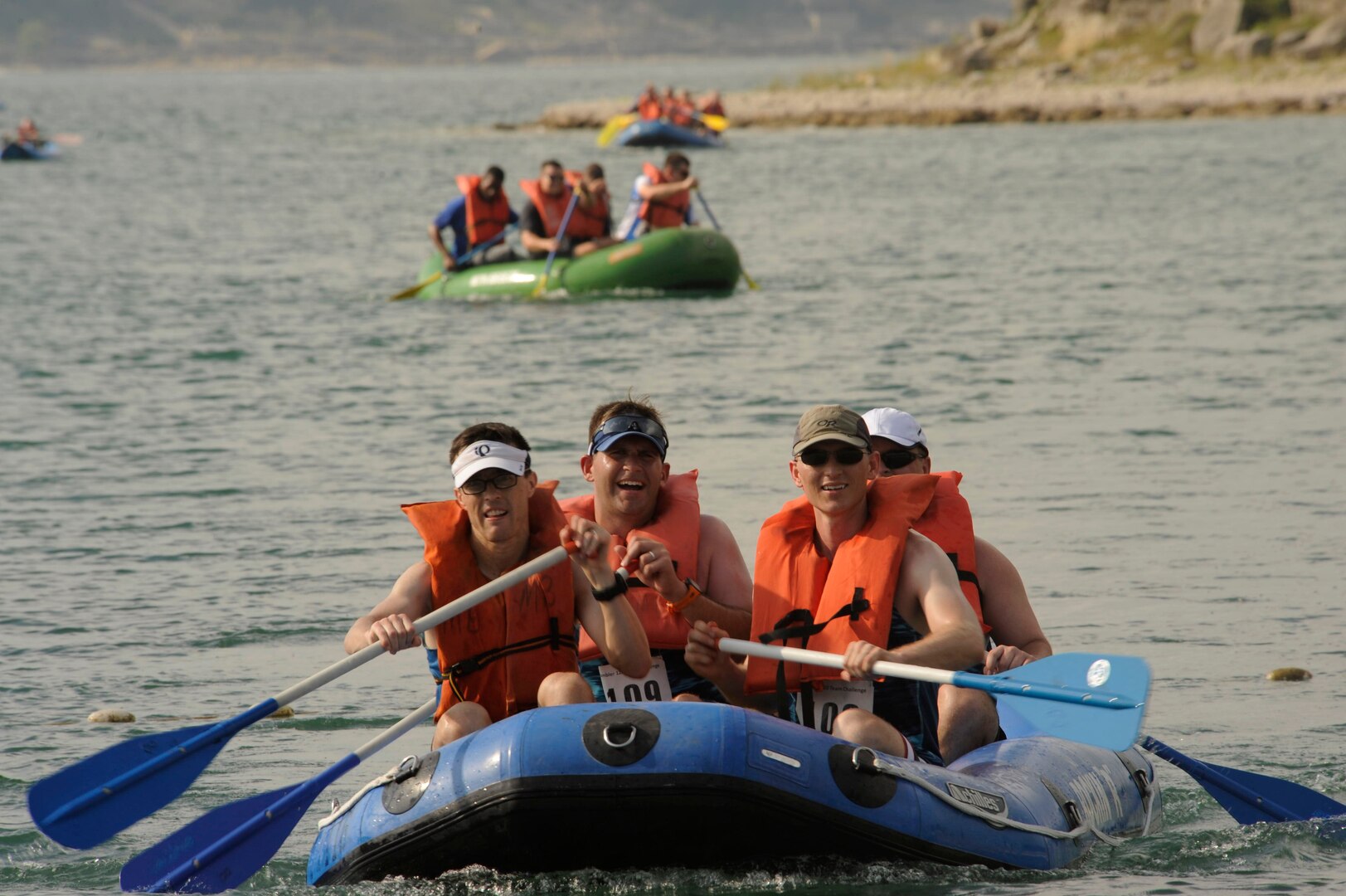 A team participating in the Rambler 120 paddle towards the shore to finish the 2-mile raft race portion, Joint Base San Antonio-Recreation Park at Canyon Lake, Texas, Oct. 14, 2017. The Rambler 120 is an annual event sponsored by the 802d Force Support Squadron that promotes teamwork and competition within the JBSA community. The event consists of a 22-mile bike ride, a 6-mile run, a 2-mile raft race and mystery obstacle.