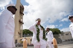 Cmdr. John C. Roussakies, commanding officer of the Virginia-class fast-attack submarine USS Hawaii (SSN 776), walks through the side boys during a change of command ceremony on the submarine piers in Joint Base Pearl Harbor-Hickam, August 2. Cmdr. Sterling S. Jordan relieved Roussakies as Hawaii’s commanding officer.