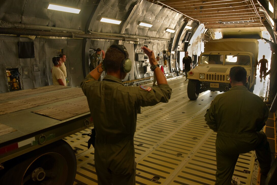 U.S. Air Force members of the 733rd Training Squadron and 356th Airlift Squadron load a vehicle into a C-5M Super Galaxy aircraft during a training exercise at Joint Base San Antonio-Lackland, Texas, Aug. 2, 2018.
