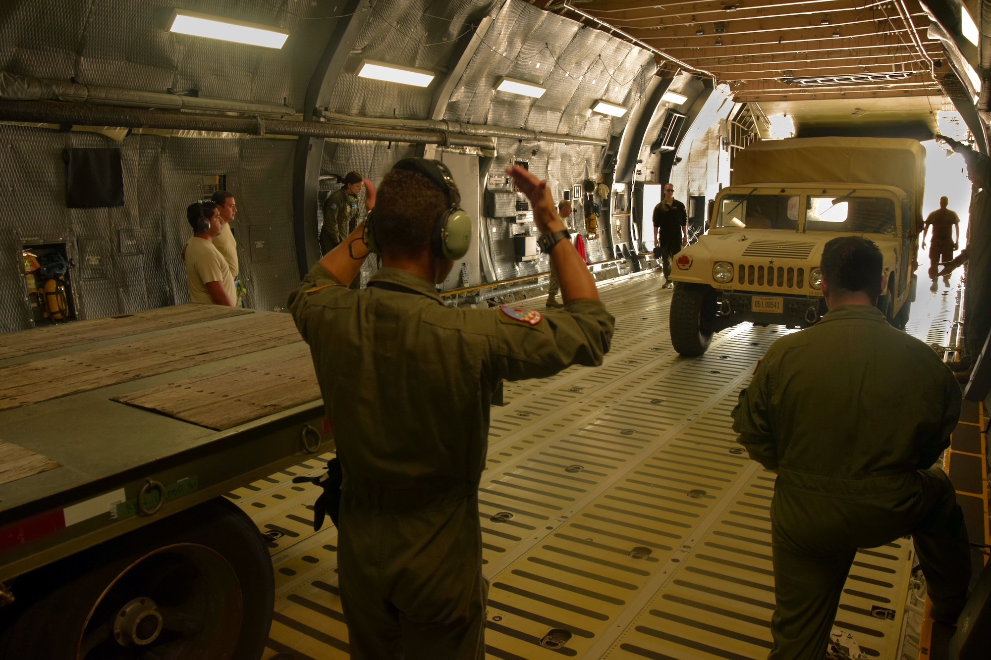 U.S. Air Force members of the 733rd Training Squadron and 356th Airlift Squadron load a vehicle into a C-5M Super Galaxy aircraft during a training exercise at Joint Base San Antonio-Lackland, Texas, Aug. 2, 2018.