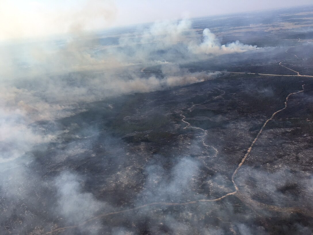 A fire burns on 8,500 acres of training ranges in Fort Hood, Texas. In a joint effort to contain the fire, Joint Terminal Attack Controllers (JTAC) from the 9th Air Support Operations Squadron, U.S. Army Blackhawks, and Royal Netherland Chinooks coordinated and performed more than 75 bucket-drops per aircraft to douse the flames. JTACs used mapping software to create a real-time map of the fire while they deconflicted the airspace for the Chinooks and Blackhawks. (Courtesy photo)