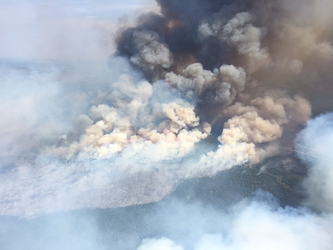 A fire burns on 8,500 acres of training ranges in Fort Hood, Texas. In a joint effort to contain the fire, Joint Terminal Attack Controllers (JTAC) from the 9th Air Support Operations Squadron, U.S. Army Blackhawks, and Royal Netherland Chinooks coordinated and performed more than 75 bucket-drops per aircraft to douse the flames. JTACs used mapping software to create a real-time map of the fire while they deconflicted the airspace for the Chinooks and Blackhawks. (Courtesy photo)