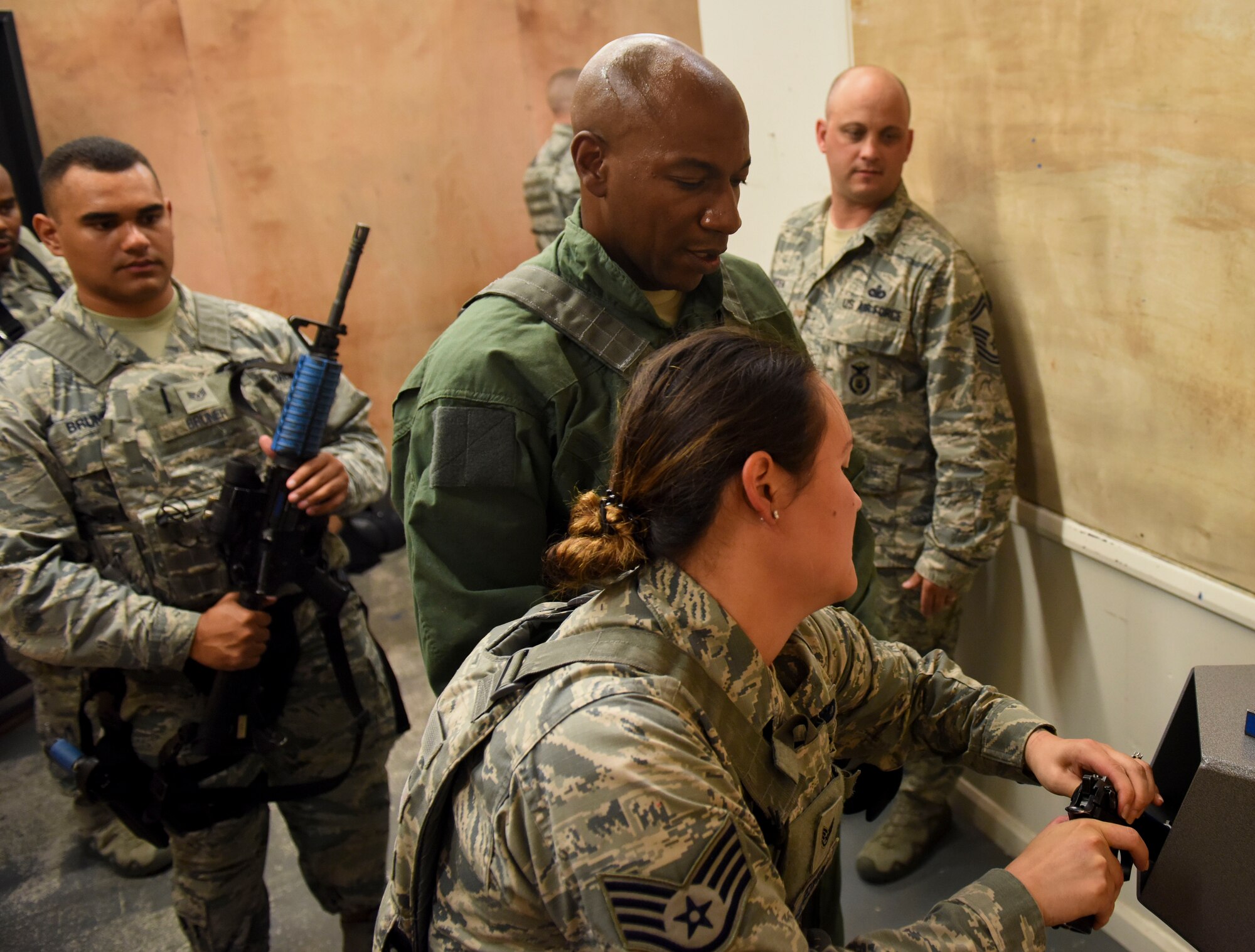 U.S. Air Force Staff Sgt. Katherine Tedrow, 100th Security Forces Squadron trainer, demonstrates how to clear a weapon during Chief Master Sgt. of the Air Force Kaleth O. Wright’s immersion tour of RAF Mildenhall, England, Aug. 2, 2018. During the visit, Wright took part in a 100th Security Forces Squadron shoot-house demonstration, participated in a Forward Area Refueling Point exercise, and spoke with RAF Mildenhall Airmen at an all-call. (U.S. Air Force photo by Senior Airman Luke Milano)