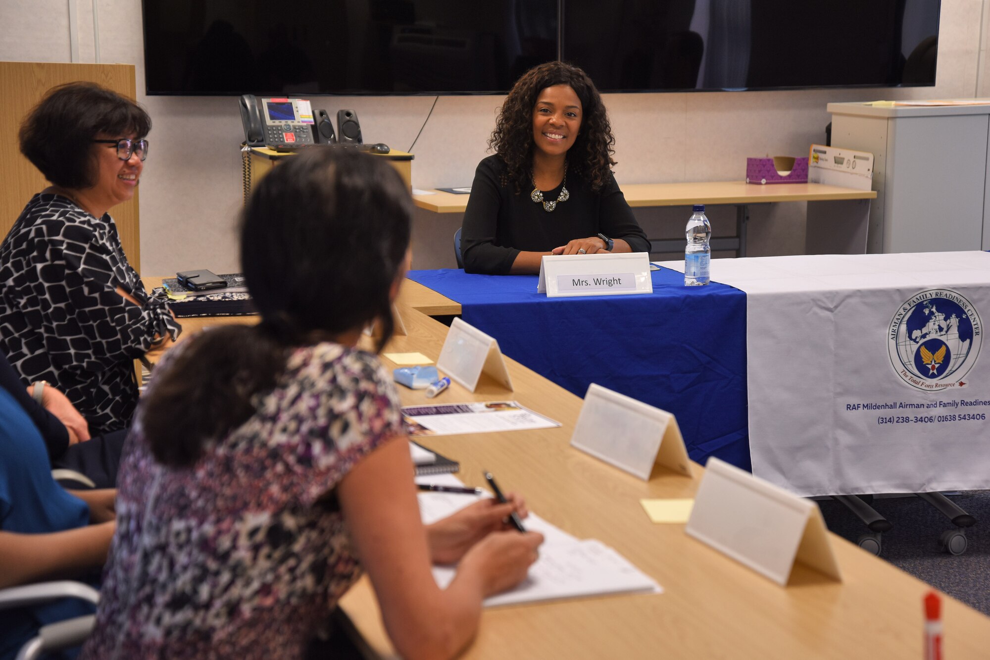 Tonya Wright, spouse of Chief Master Sgt. of the Air Force Kaleth O. Wright, visits with representatives from base family support agencies at the Airman & Family Readiness Center at RAF Mildenhall, England, Aug. 2, 2018. During her visit, Mrs. Wright met with multiple units to see how Team Mildenhall takes care of U.S. Air Force families with local support and service programs. (U.S. Air Force photo by Senior Airman Christine Groening)