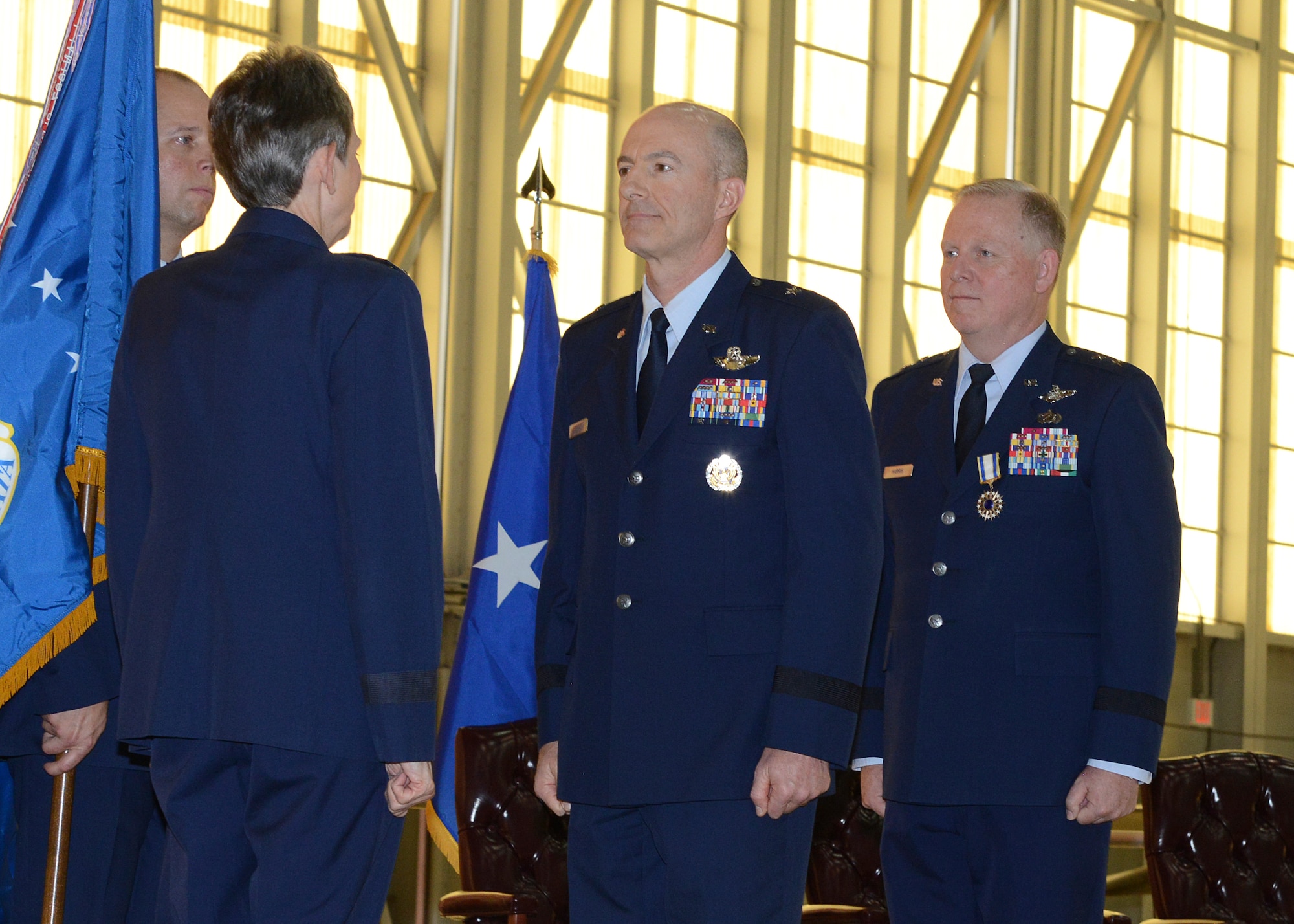 Brig. Gen. Christopher P. Azzano (center), accepts command of the Air Force Test Center from Gen. Ellen Pawlikowski, Air Force Materiel Command commander, during a change-of-command ceremony Aug. 3 at Edwards Air Force Base. Azzano replaces Maj. Gen. David Harris (right) who is retiring from the Air Force. (U.S. Air Force photo by Kenji Thuloweit)