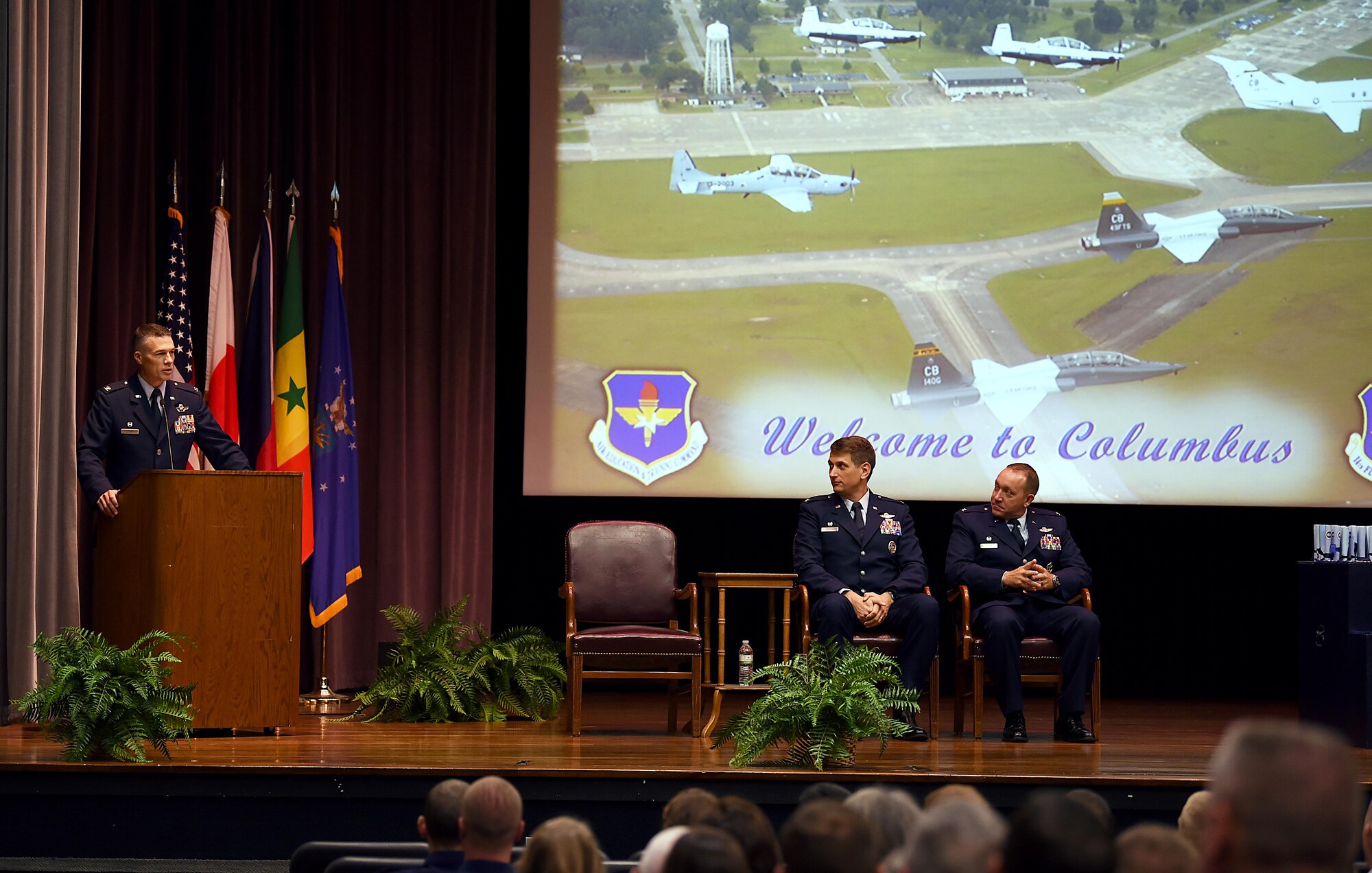 Col. Douglas Gosney, 14th Flying Training Wing commander, introduces Col. David Gordon, 2nd Operations Group commander at Barksdale Air Force Base, Louisiana, as the guest speaker for Specialized Undergraduate Pilot Training Class 18-12 July 27, 2018, on Columbus Air Force Base, Mississippi. Gosney and Gordon both flew the B-52 Stratofortress and eventually worked together, becoming friends years ago. (U.S Air Force photo by Airman 1st Class Keith Holcomb)