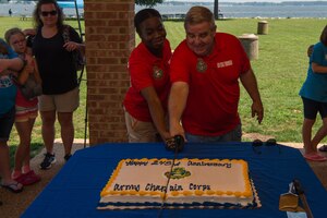 From left, U.S. Army Pvt. Jazmyn Lovett, Regimental Memorial Chapel religious affairs specialist, and Col. Darrell Thomsen, Joint Base Langley-Eustis deputy wing chaplain, cut the cake during the U.S. Army Chaplain Corps 243rd Anniversary celebration at Yorktown, Virginia, July 27, 2018.