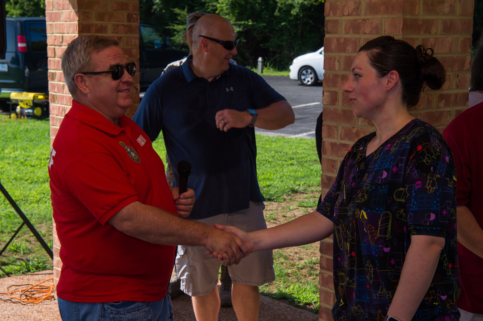 U.S. Army Col. Darrell Thomsen, Joint Base Langley-Eustis deputy wing chaplain, presents a coin to U.S. Army Sgt. Christa Zayas, 128th Aviation Brigade religious affairs specialist, during the U.S. Army Chaplain Corps 243rd Anniversary at Yorktown, Virginia, July 27, 2018.