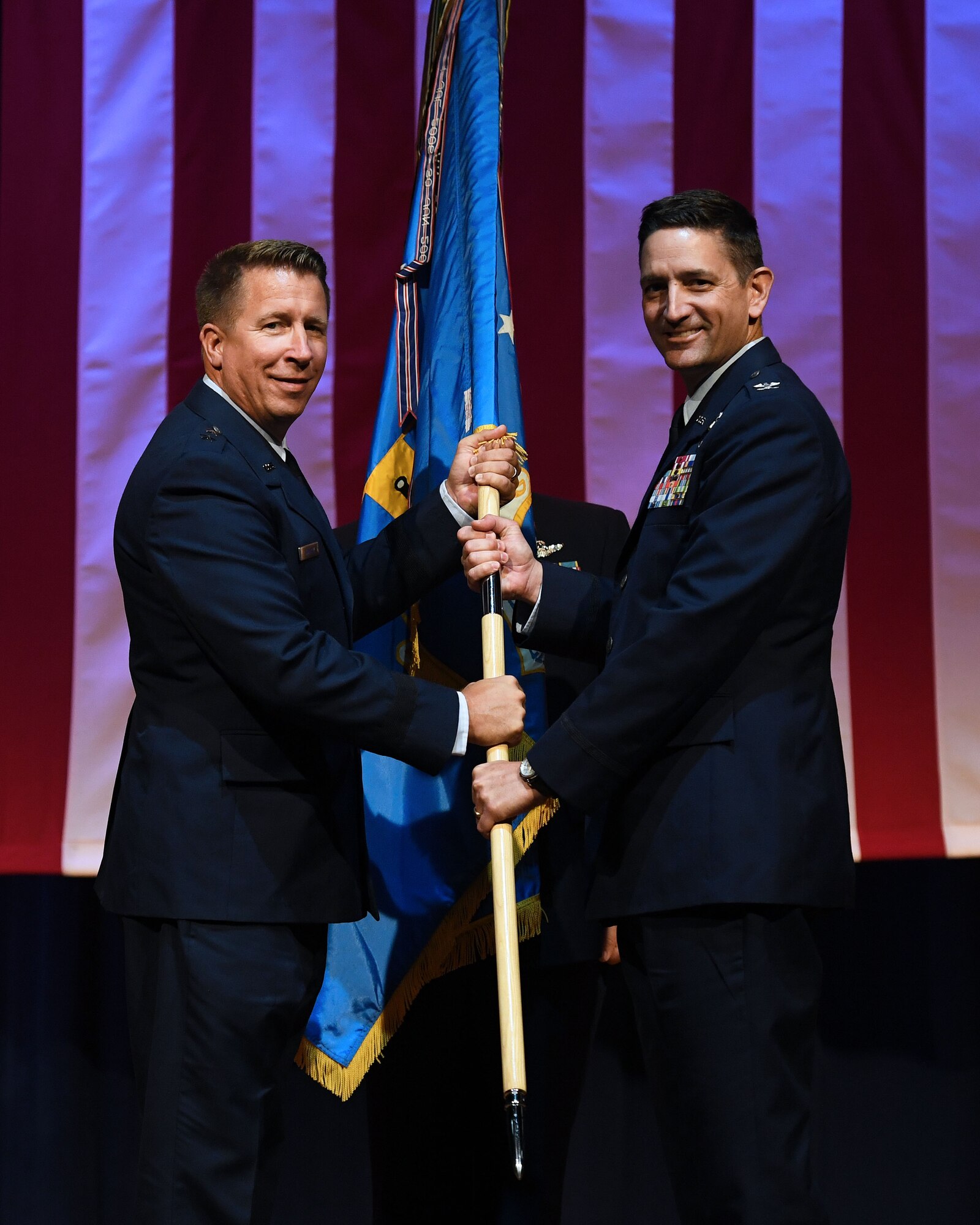 Two men hold a flag.