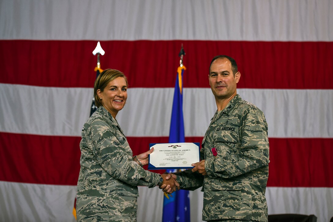 Col. Jennifer Short, 23d Wing commander, left, presents Col. Jay Vietas, 23d Medical Group commander, with the Legion of Merit during a change of command ceremony, Aug. 3, 2018, at Moody Air Force Base, Ga. During his tenure, Vietas led 280 staff members in providing outpatient medical, dental, occupational, environmental and preventive healthcare services in support of two combat ready wings. (U.S. Air Force photo by Senior Airman Greg Nash)