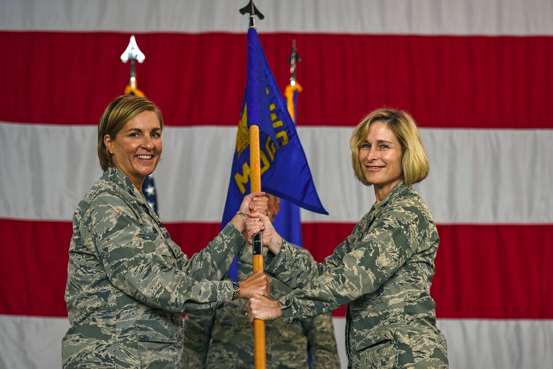 Col. Jennifer Short, 23d Wing commander, left, presents a guidon to Col. Tiffany Morgan as she assumes command of the 23d Medical Group during a change of command ceremony, Aug. 3, 2018, at Moody Air Force Base, Ga. Morgan commands the 23d MDG, who provides outpatient medical, dental, occupational, environmental and preventive healthcare services in support of two combat ready wings. (U.S. Air Force photo by Senior Airman Greg Nash)