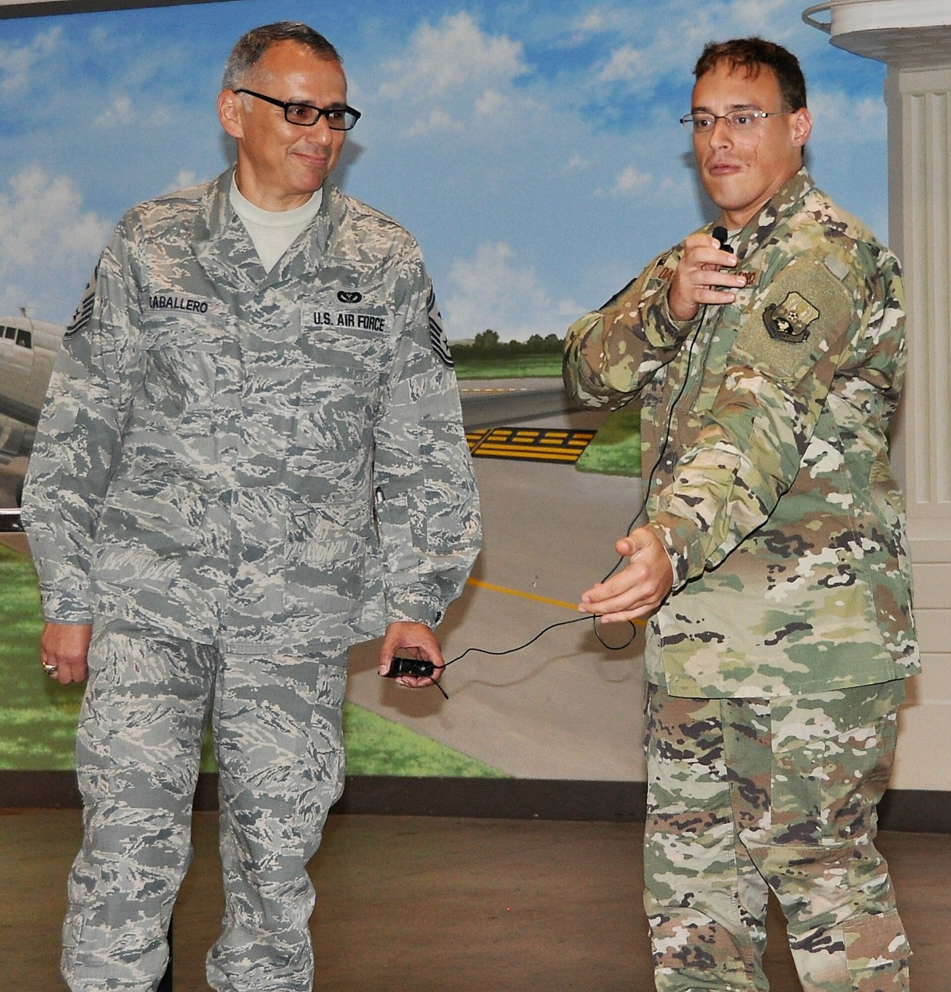 340th Flying Training Group First Sergeant, Samuel Caballero looks on as Tech. Sgt. Brett Daniel shares information about the single combat utility uniform that Air Force leaders announced the service would move to on May 14. Daniel presented the demonstration during the unit’s 2018 Enlisted Summit held July 23-26 at the Hangar Hotel in Fredericksburg, Texas. (Air Force photo by Janis El Shabazz)
