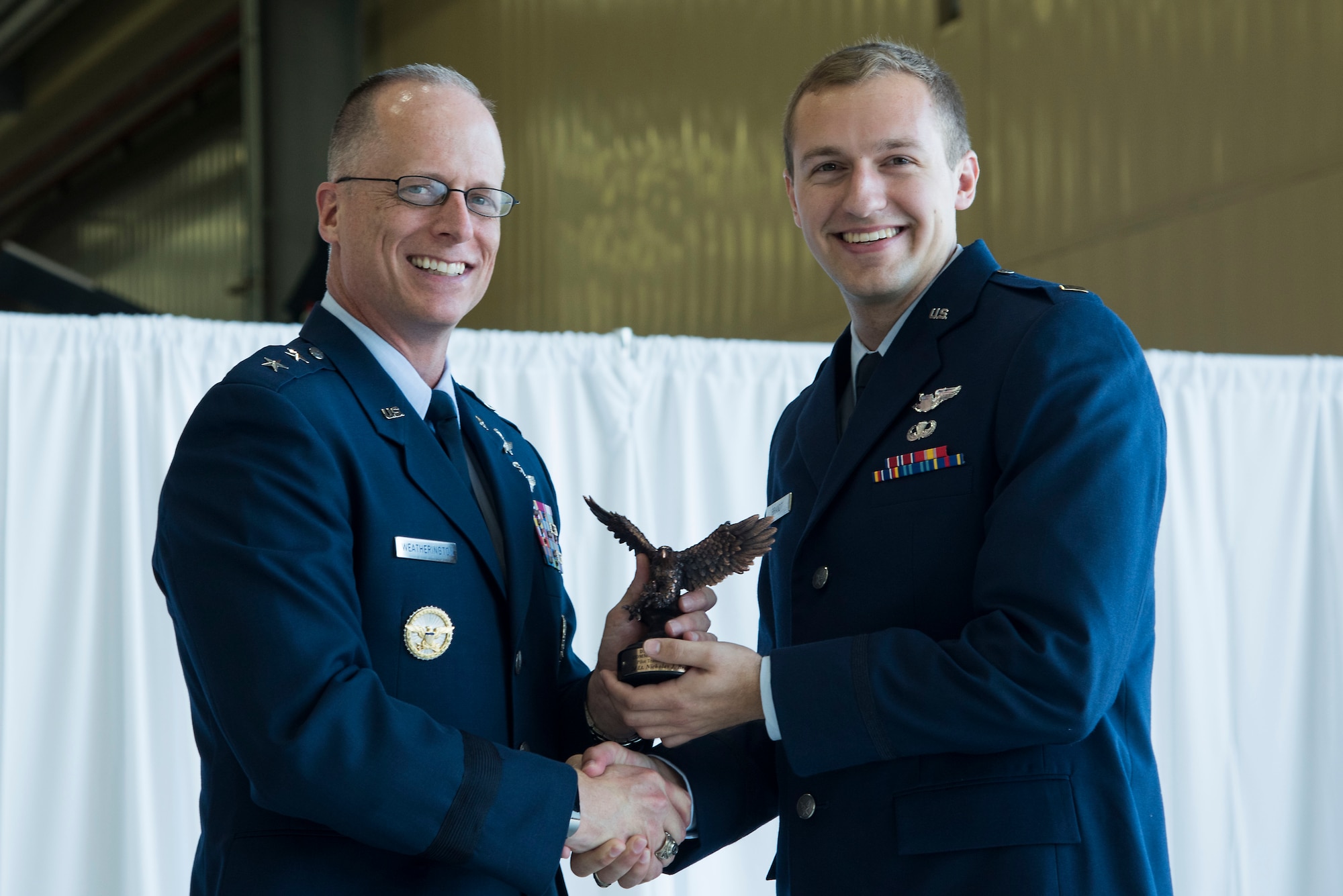 U.S. Air Force 2nd Lt. Nicholas Brandt, Pilot Training Next graduate receives the commander’s graduate award during the first ever Pilot Training Next graduation August 3, 2018 at the Texas Army National Guard Hangar in Austin, Texas. PTN is a program to explore and potentially prototype a training environment that integrates various technologies to produce pilots in an accelerated, cost efficient, learning-focused manner. (U.S. Air Force photo by Senior Airman Gwendalyn Smith)