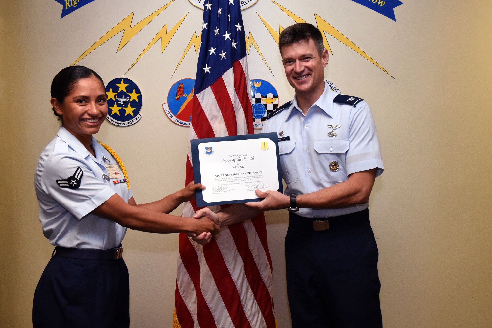 U.S. Air Force Airman 1st Class Tania Sebrero Hernandez, 315th Training Squadron student, receives the 17th Training Group Rope of the Month award from Col. Thomas Coakley, 17th Training Group commander, at Brandenburg Hall on Goodfellow Air Force Base, Texas, Aug. 3, 2018. Military Training Leaders present ropes to Airmen who display exceptional leadership qualities to lead their peers. (U.S. Air Force photo by Airman 1st Class Seraiah Hines/Released)