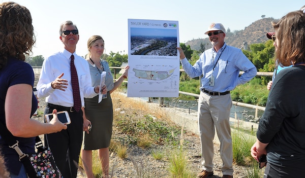 Gary Lee Moore, Los Angeles city engineer, second from left, talks to students and instructors with the U.S. Army Corps of Engineers Planning Associates Program about plans for ecosystem restoration along the Los Angeles River during the group's July 25 bus tour of Los Angeles County watersheds.