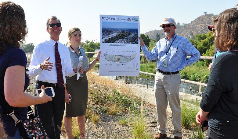 Gary Lee Moore, Los Angeles city engineer, second from left, talks to students and instructors with the U.S. Army Corps of Engineers Planning Associates Program about plans for ecosystem restoration along the Los Angeles River during the group's July 25 bus tour of Los Angeles County watersheds.