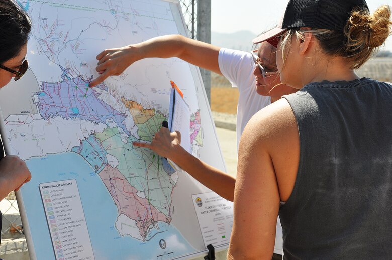 Eileen Takata, lead water resources planner, U.S. Army Corps of Engineers Los Angeles District, second from right, shows the area of responsibility for the Corps and the Los Angeles County Flood Control District in managing flood risk in the Greater Los Angeles Basin area during a July 25 visit to see water storage areas near Hansen Dam.
