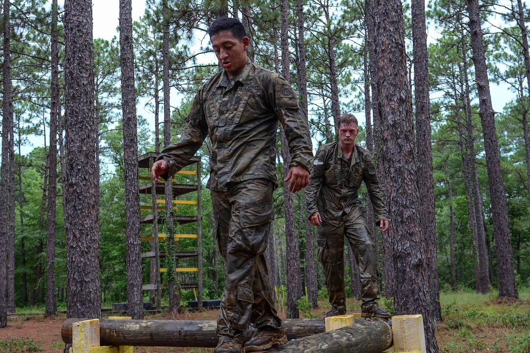 Soldiers navigate along the balance obstacle course.