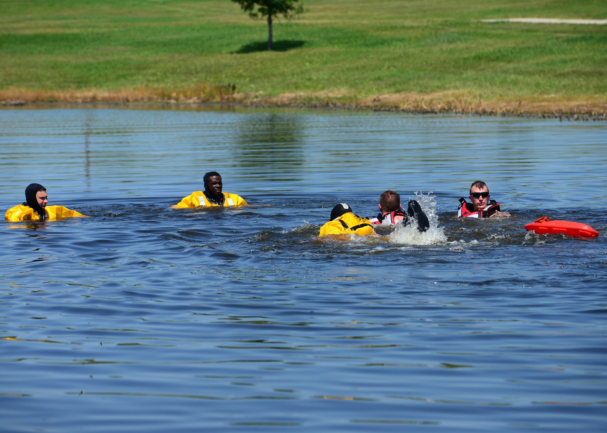 Airmen from the 28th Civil Engineer Squadron’s fire department conduct water rescue training in the base lakes at Ellsworth Air Force Base, S.D., July 31, 2018. During this training, the Airmen reviewed proper placements and techniques for rescuing a person who is drowning. (U.S. Air Force photo by Senior Airman Denise M. Jenson)