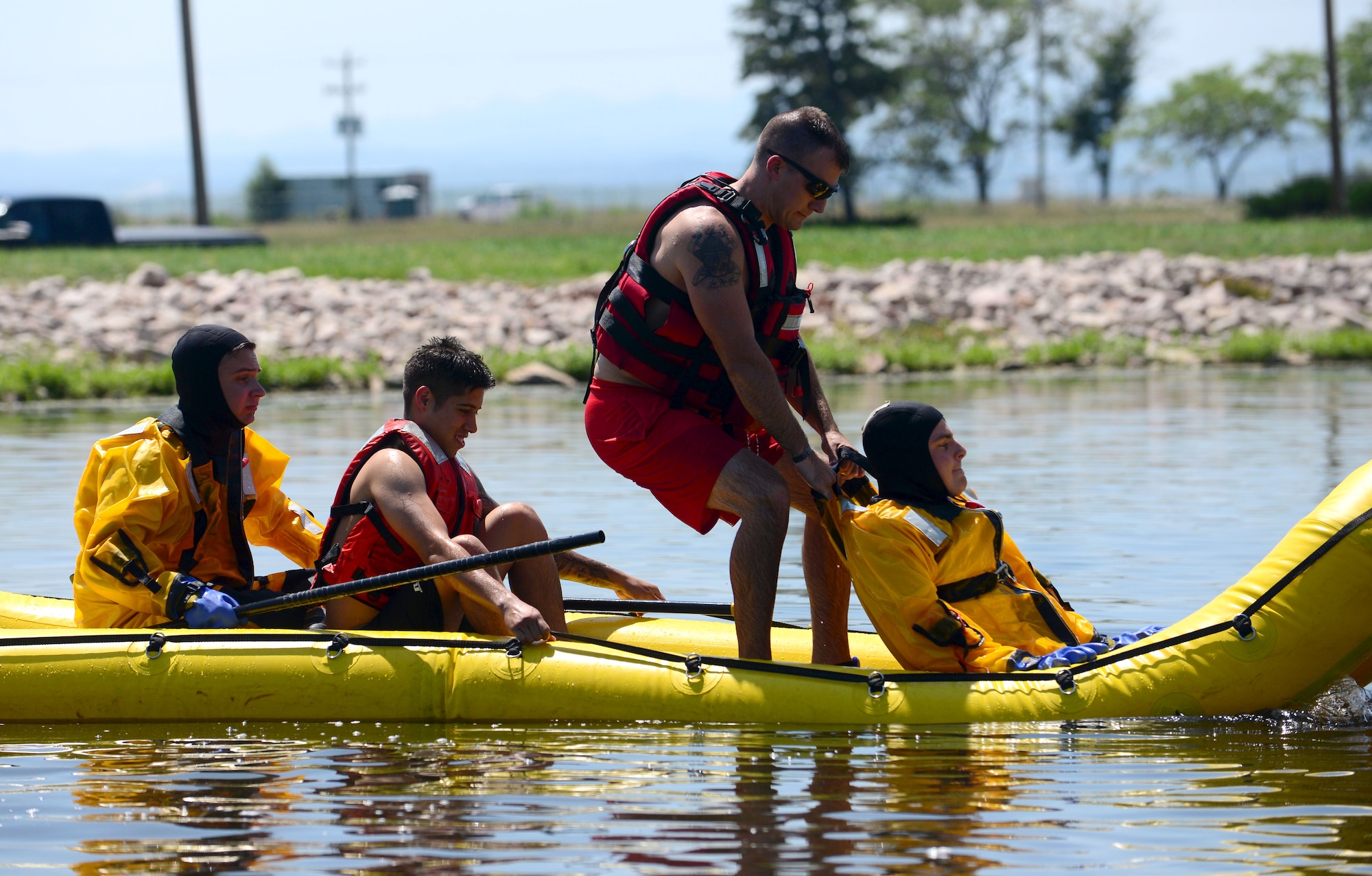 Staff Sgt. Jordan LaPoint, a 28th Civil Engineer Squadron fire and emergency services crew chief, pulls a simulated drowning person inside a boat during water rescue training in the base lakes at Ellsworth Air Force Base, S.D., July 31, 2018. When there are no fires threatening the base, the firefighters conduct routine training to ensure they are prepared for any situation where they are needed. (U.S. Air Force photo by Senior Airman Denise M. Jenson)