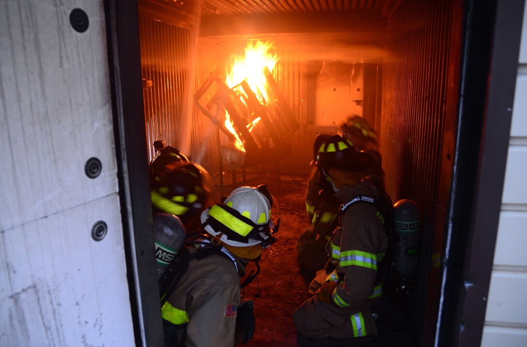 A team of firefighters from the South Dakota National Guard and Ellsworth Air Force Base, S.D., watches as a fire blazes during a nighttime fire training session at Ellsworth AFB, Aug. 2, 2018. Ellsworth AFB’s fire department often conducts joint training missions with both local fire departments and the South Dakota National Guard. (U.S. Air Force photo by Senior Airman Denise M. Jenson)