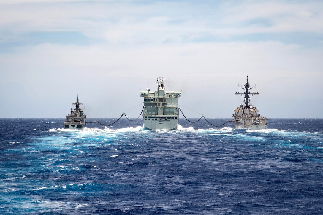 Navy ships conduct a replenishment-at-sea.
