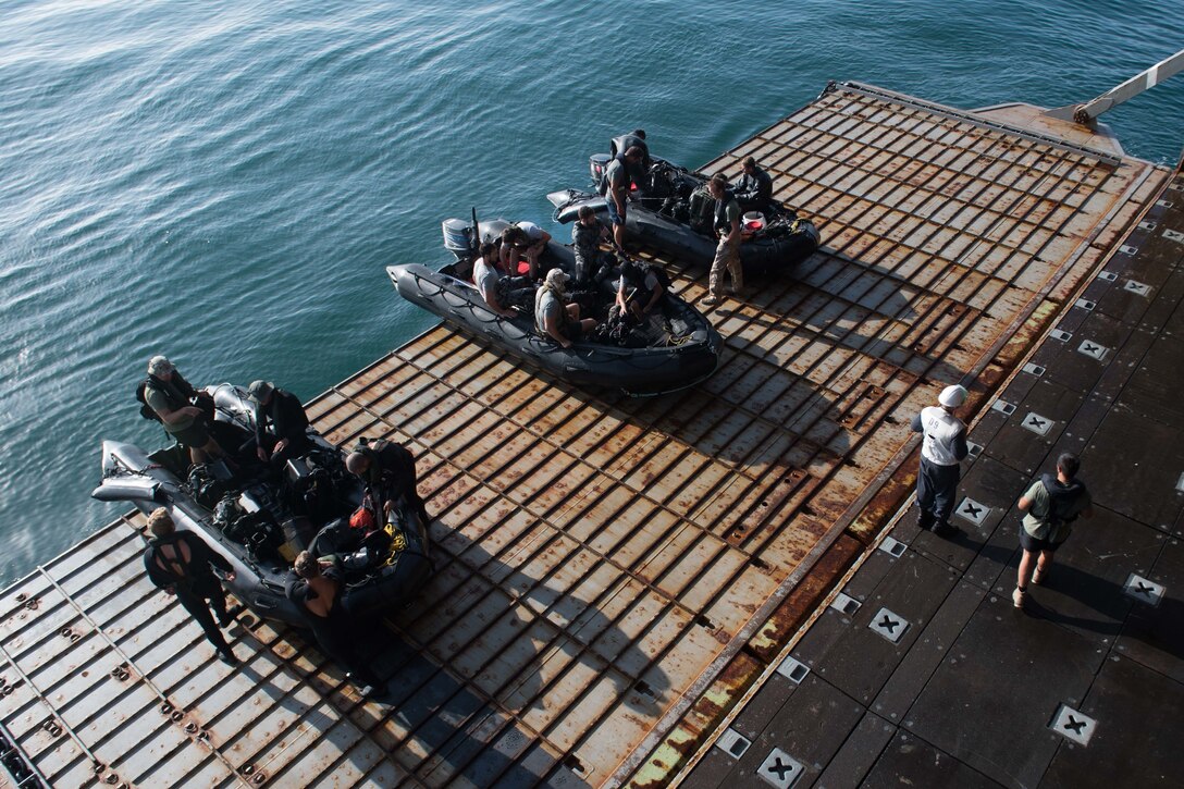 Sailors prepare to launch combat rubber raiding crafts.