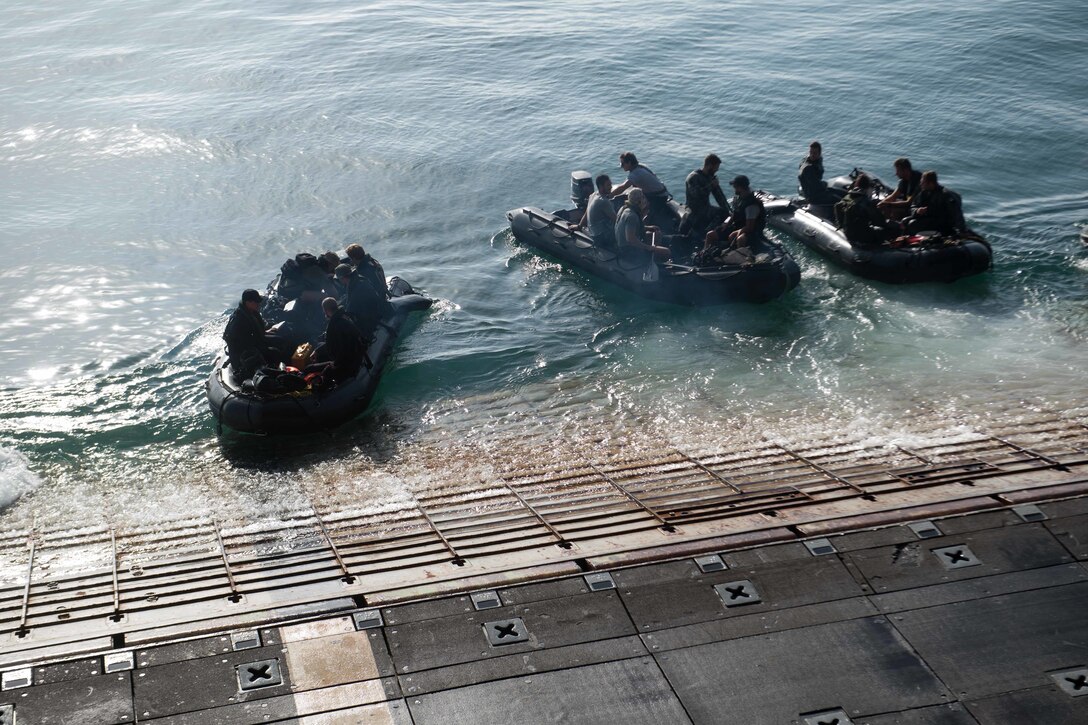 Sailors launch combat rubber raiding crafts.