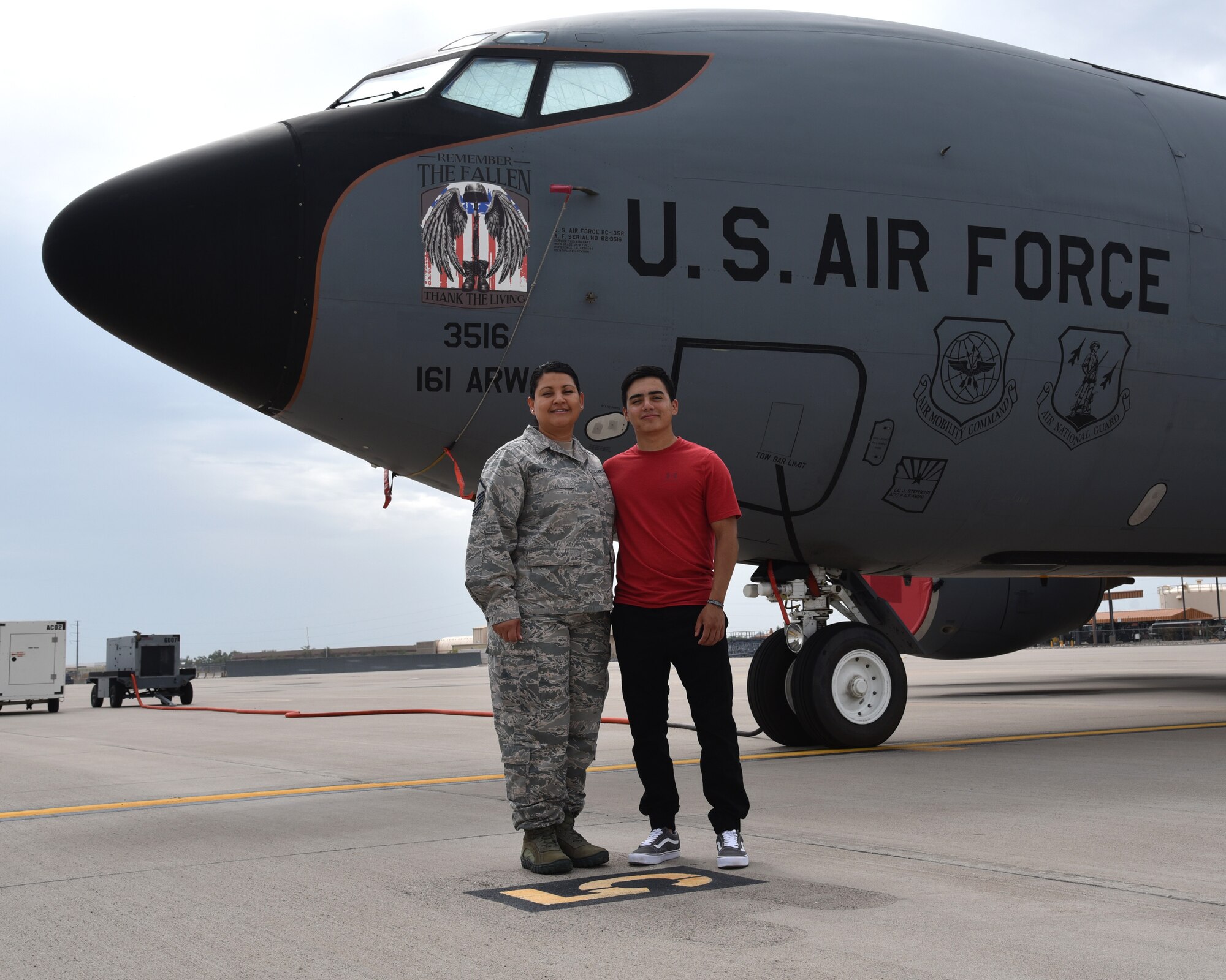 U.S. Air Force Master Sgt. Maria Breceda, the 161st Air Refueling Wing’s administrative assistant, poses with her son, U.S. Army Pfc. Michael Breceda, an airborne infantryman with the 25th Infantry Division, in front of a KC-135R Stratotanker on the flight line at Goldwater Air National Guard Base, Phoenix, July 10. An aircrew from the 161st ARW conducting an in-flight refueling to A-10 Thunderbolt II’s providing close air support to members of Private Breceda’s battalion during ground combat April 30.  (U.S. Air National Guard photo by Staff Sgt. Wes Parrell)