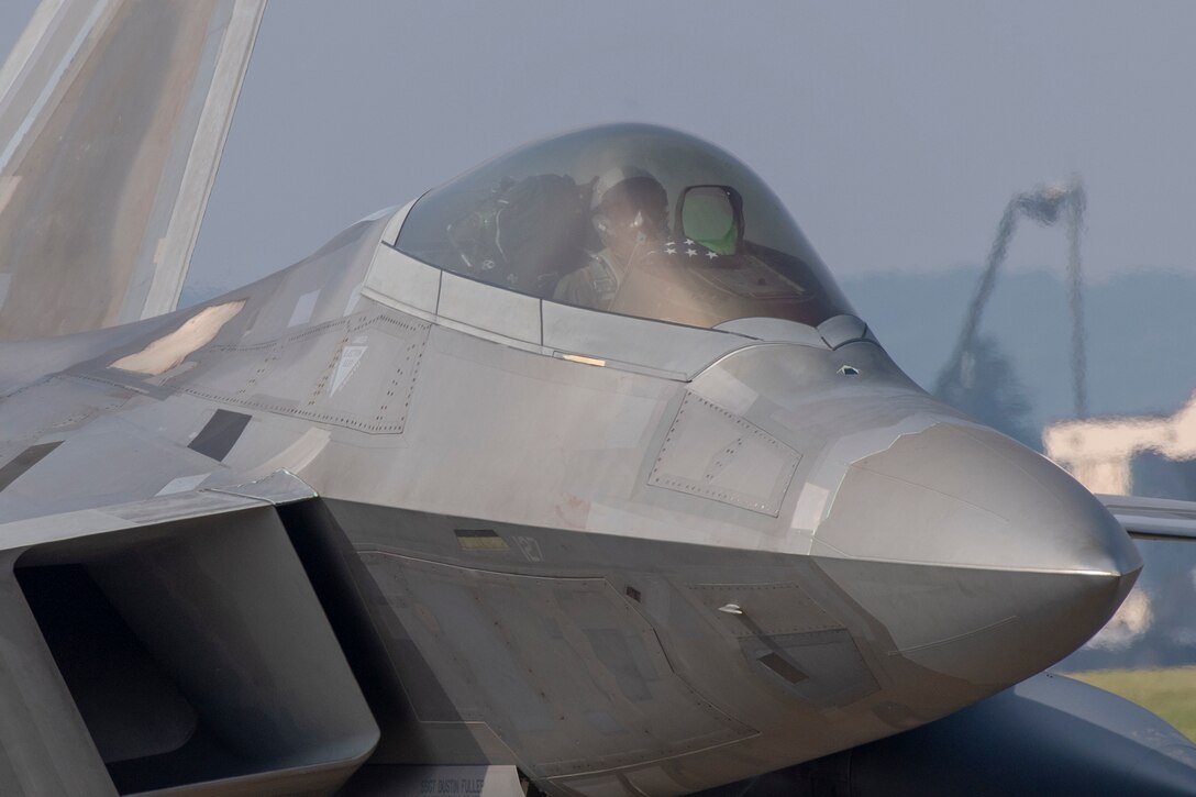 An F-22 Raptor taxis down the flightline at Yokota Air Base, Japan