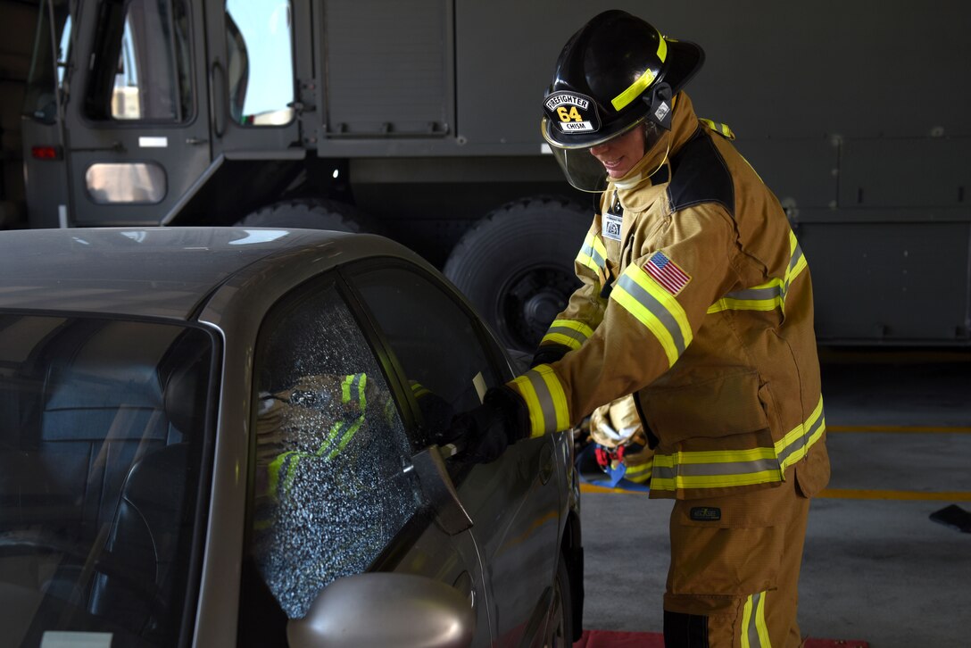 U.S. Air Force Chief Master Sgt. Franklin Chism, 51st Mission Support Group superintendent, breaks the window of a vehicle during an immersion tour with the 51st Civil Engineer Squadron Fire and Emergency Services flight at Osan Air Base, Republic of Korea, Aug. 3, 2018. Not only did leadership get a taste of fighting fires, they also learned other aspects of the firefighters’ job such as search and rescue. (U.S. Air Force photo by Senior Airman Kelsey Tucker)