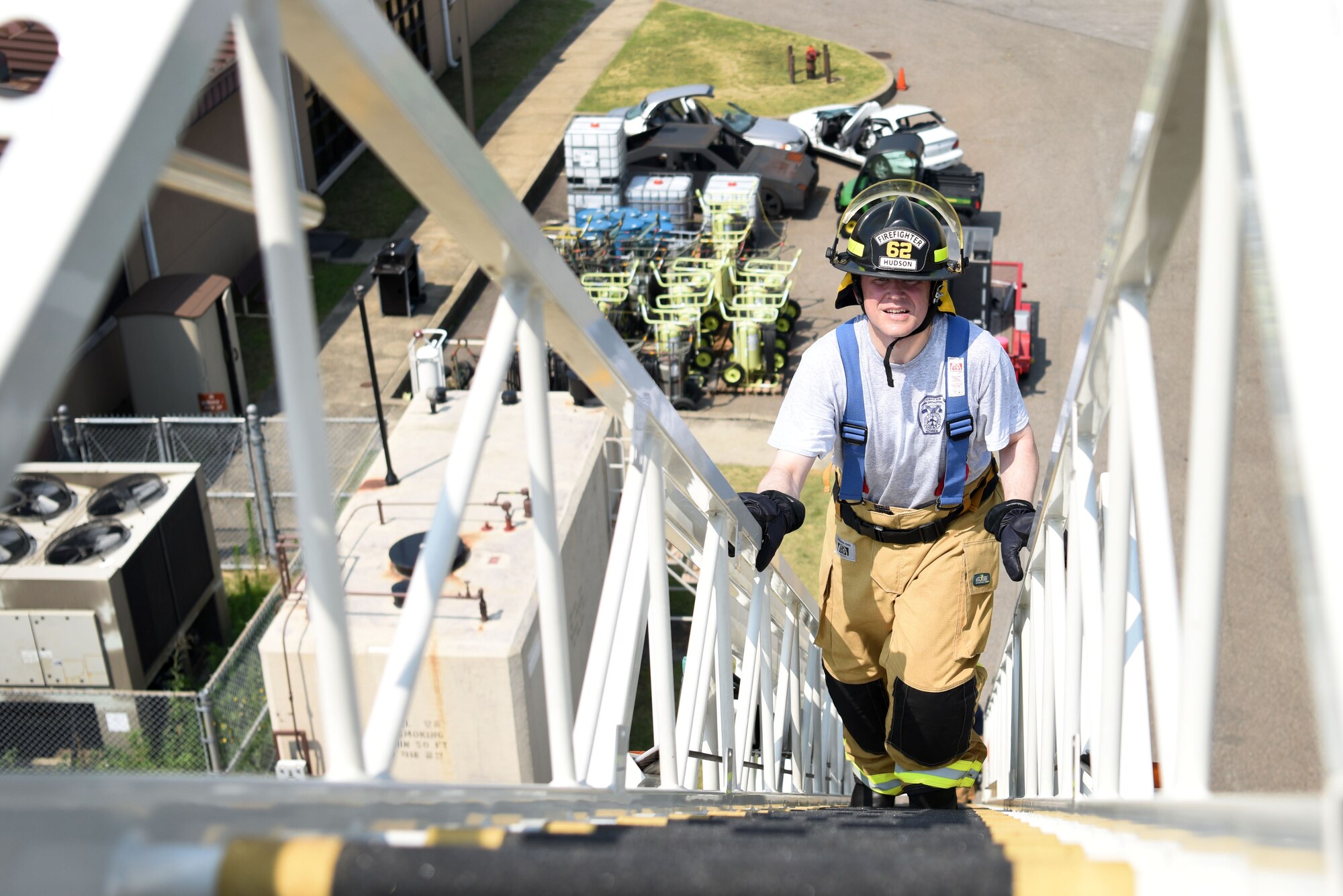 U.S. Air Force Chief Master Sgt. Philip Hudson, 51st Fighter Wing command chief, scales a ladder truck during an immersion tour with the 51st Civil Engineer Squadron Fire and Emergency Services flight at Osan Air Base, Republic of Korea, Aug. 3, 2018. The fire engine’s ladder reaches to 100 feet tall, just under the 7th story of most buildings on base. (U.S. Air Force photo by Senior Airman Kelsey Tucker)