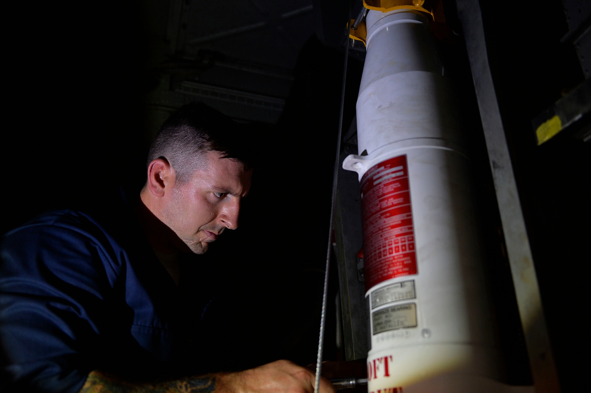 U.S. Air Force Staff Sgt. Andrew Jean, 86th Aircraft Maintenance Squadron aerospace repair crew chief, installs a strut in the wheel well of a C-130J Super Hercules on Powidz Air Base, Poland, Aug. 3, 2018. Struts are shock absorbers found in the landing gear of aircraft which help mitigate the impact of landing. (U.S. Air Force photo by Senior Airman Joshua Magbanua)