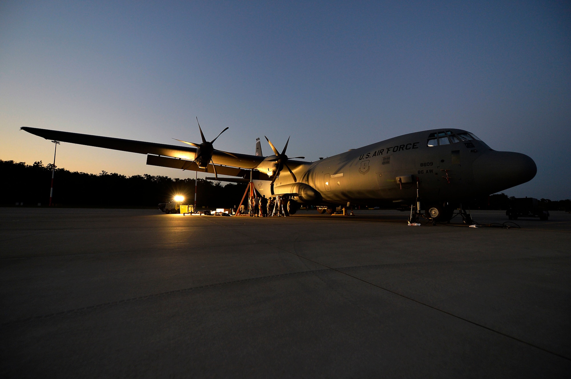 U.S. Airmen assigned to the 86th Aircraft Maintenance Squadron conduct maintenance work on a U.S. C-130J Super Hercules on Powidz Air Base, Poland. The Airmen worked through the night replacing one of its struts, which are used in landing gear to absorb shock. (U.S. Air Force photo by Senior Airman Joshua Magbanua)