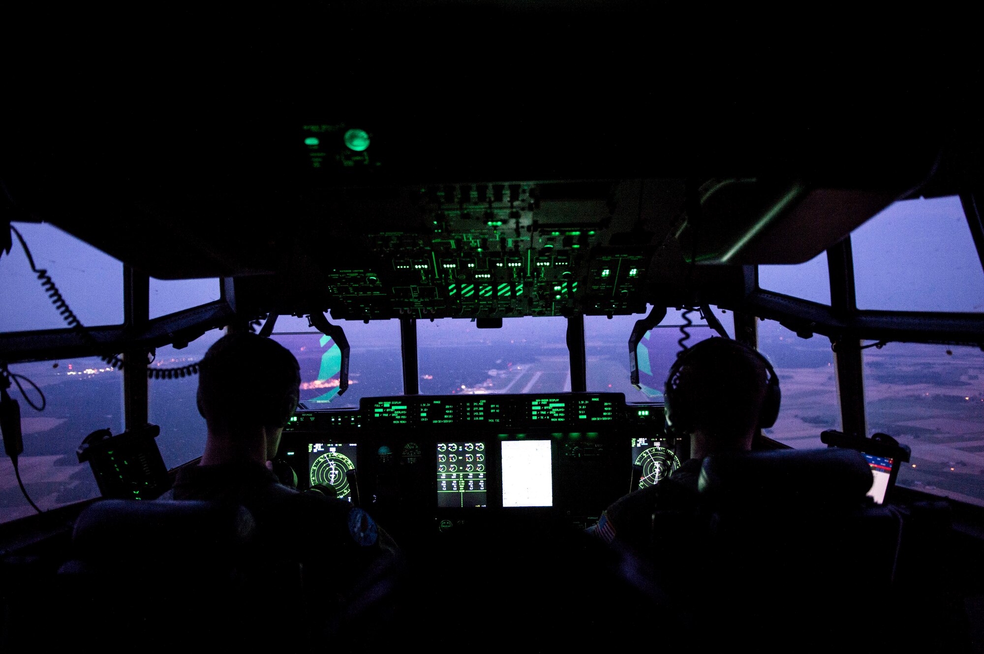 U.S. Air Force Capt. Leland Quinter, left, and U.S. Air Force Capt. Pete Wolber, both 37th Airlift Squadron C-130J Super Hercules pilots, conduct a training flight over Poland, Aug. 2, 2018. Approximately 100 U.S. Airmen and three aircraft arrived in Poland to conduct bilateral exercises with the Polish Air Force. (U.S. Air Force photo by Senior Airman Joshua Magbanua)