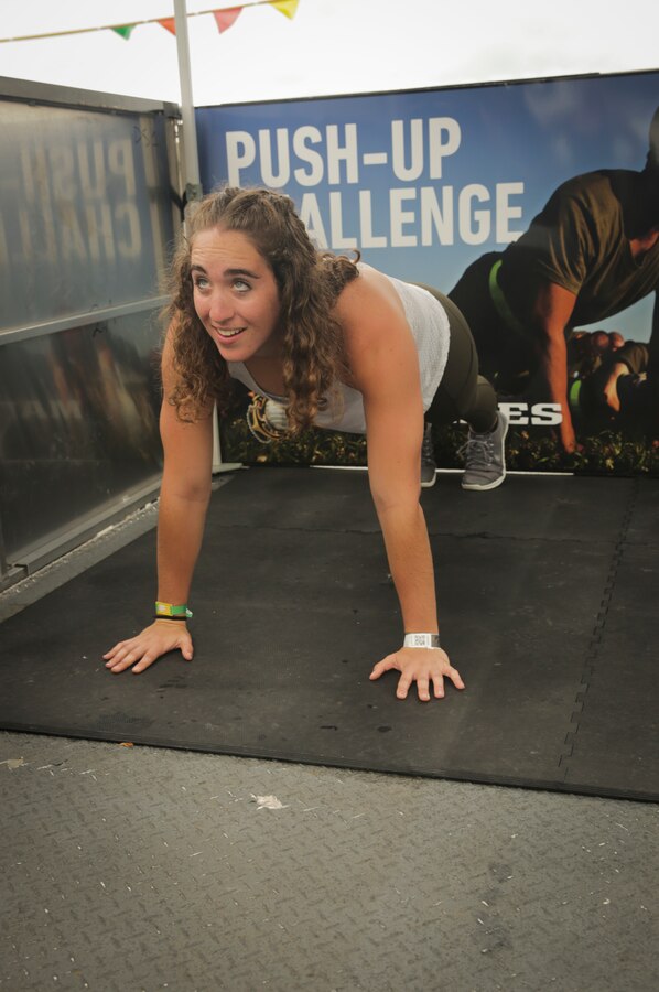 MADISON, Wisconsin – Morgan Laughlin, a native of Cincinnati, Ohio, executes a push-up at the Marine Corps Battles Won Challenge trailer during the 2018 Reebok CrossFit Games at the Alliant Energy Center, August 2. CrossFit promotes both a physical exercise philosophy and competitiveness, working to incorporate elements from high-interval training, Olympic weightlifting, Plyometrics, powerlifting, gymnastics, calisthenics, strongman, and many others. CrossFit Athletes share many of the same values as those exhibited by Marines. (U.S. Marine Corps photo by LCpl. Haley Gawronski)