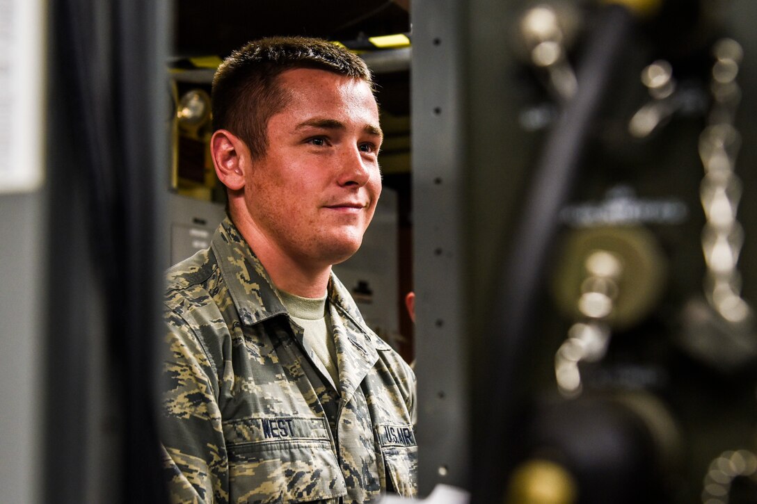 An airman smiles for a photo.