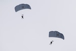 Alaska Air National Guard Guardian Angel personnel assigned to the 212th Rescue Squadron descend over Malemute drop zone during precision parachute training at Joint Base Elmendorf-Richardson, Alaska, Jan. 24, 2018. The busiest rescue force in the Department of Defense, the 212th Rescue Squadron provides elite pararescuemen (PJs), combat rescue officers (CROs) and Survival, Evasion, Resistance, and Escape (SERE) specialists to carry out the 176th Wing’s wartime and peacetime rescue missions.