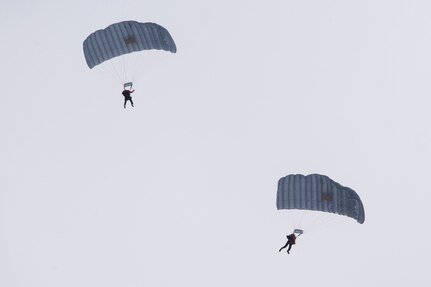 Alaska Air National Guard Guardian Angel personnel assigned to the 212th Rescue Squadron descend over Malemute drop zone during precision parachute training at Joint Base Elmendorf-Richardson, Alaska, Jan. 24, 2018. The busiest rescue force in the Department of Defense, the 212th Rescue Squadron provides elite pararescuemen (PJs), combat rescue officers (CROs) and Survival, Evasion, Resistance, and Escape (SERE) specialists to carry out the 176th Wing’s wartime and peacetime rescue missions.