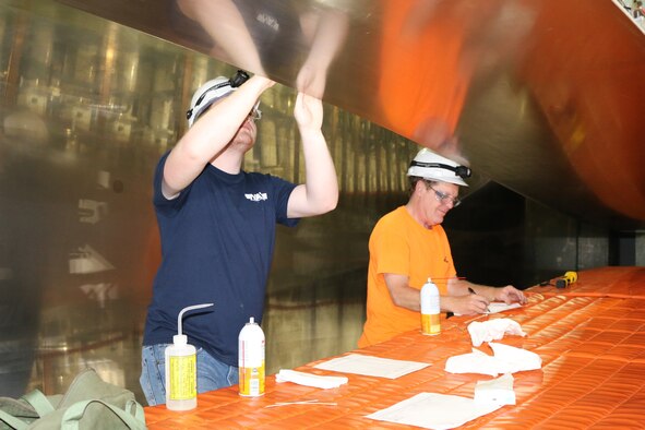 Gage Seals and Terry Bush, instrumentation technicians at Arnold Air Force Base, clean part of the Tunnel A nozzle at the von Kármán Facility. Periodic maintenance of the facilities is one of the many duties of an instrumentation technician’s duties at Arnold. (U.S. Air Force photo by Deidre Ortiz)