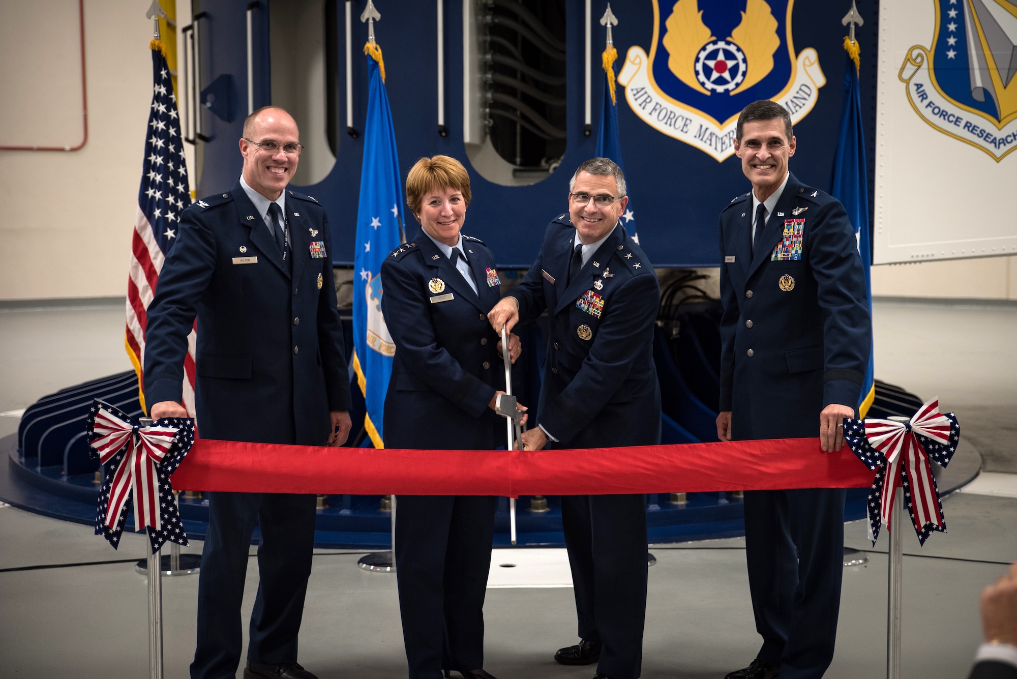 Col. Alden Hilton, United States Air Force School of Aerospace Medicine commander, Lt. Gen. Dorothy Hogg, Air Force Surgeon General, Maj. Gen. William Cooley, Air Force Research Laboratory commander, and Brig. Gen. Mark Koeniger, 711th Human Performance Wing commander, pose just before cutting the ribbon during a ceremony Aug. 2 in USAFSAM to mark the full operational capability of the Department of Defense’s only human-rated centrifuge. (U.S. Air Force photo by Richard Eldridge)